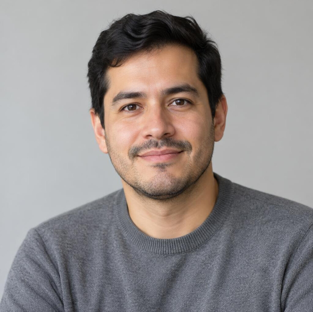 Portrait of a man with short dark hair and light stubble